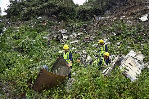 Rescuers search a plane crash site at TIA in Kathmandu